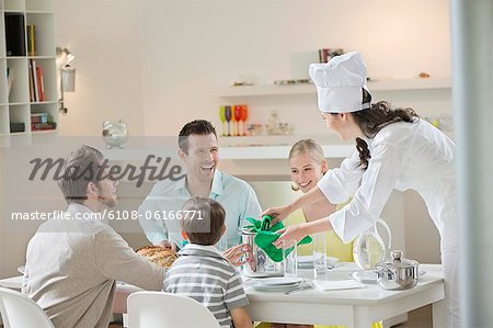 Woman serving lunch at dining table