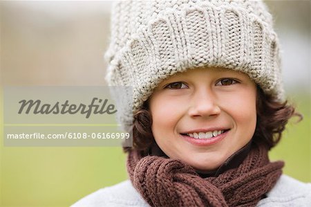 Portrait of a boy wearing a knit hat and smiling