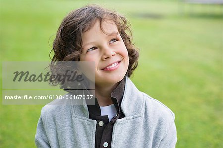 Close-up of a boy smiling in a field