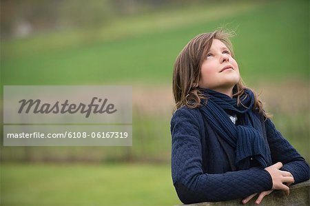 Girl looking up in a farm
