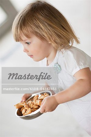 Girl carrying a bowl of food