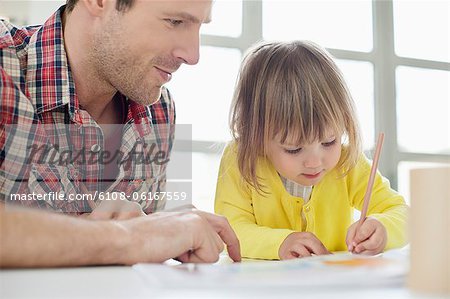 Man teaching his daughter