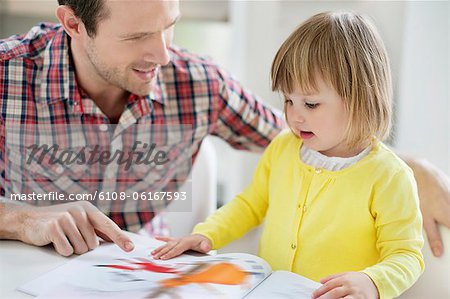 Man teaching his daughter Man teaching his daughter