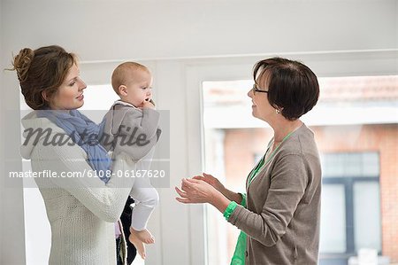 Woman giving her daughter to nanny
