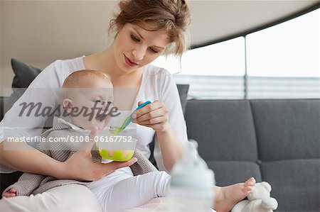 Woman feeding her daughter