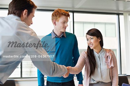 Business executive shaking hands with his clients