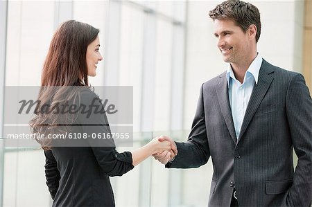 Business executives shaking hands in an office