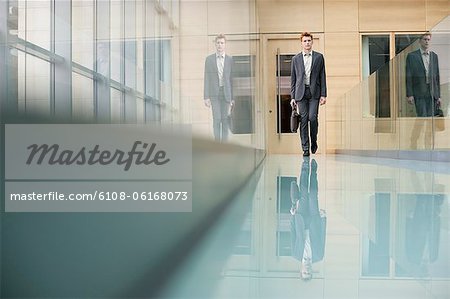 Businessman walking in an office corridor