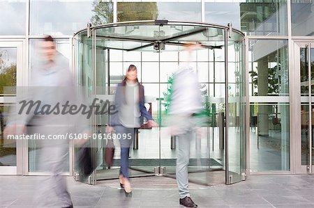 Business executives at entrance of an office building