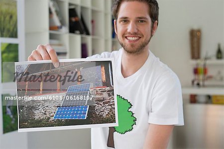 Man showing an ecological poster of solar panel