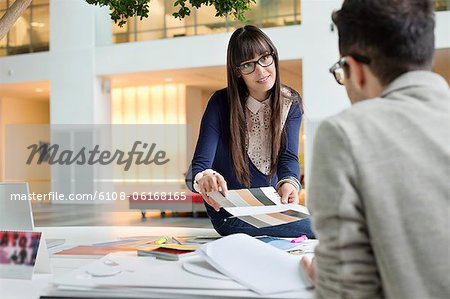 Fashion designers discussing in an office