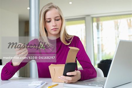 Geschäftsfrau Salat essen, während der Arbeit im home-office