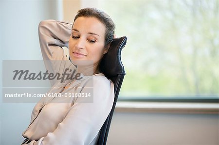 Businesswoman day dreaming in an office