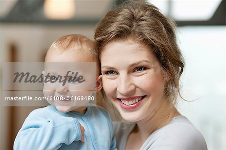 Close-up of a woman smiling with her baby girl