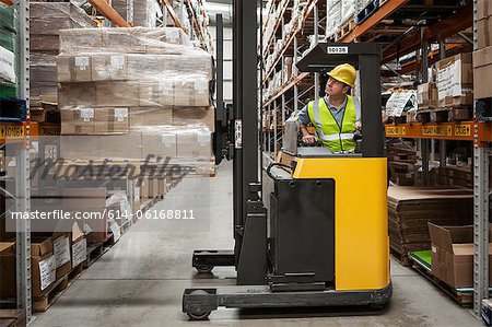 Man transporting stock in distribution warehouse