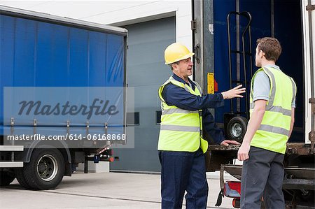 Two men loading truck