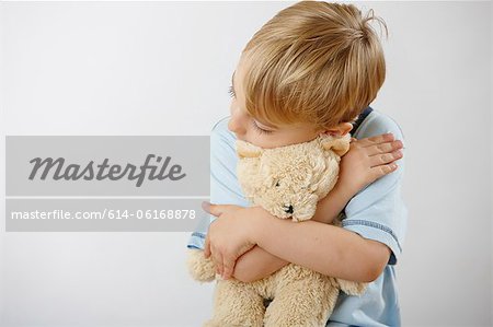 Boy hugging teddy