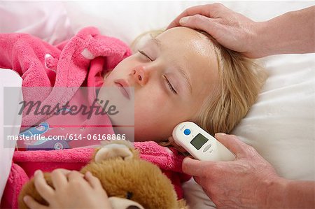 Parent taking daughter's temperature