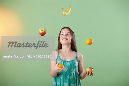 Girl juggling fruit