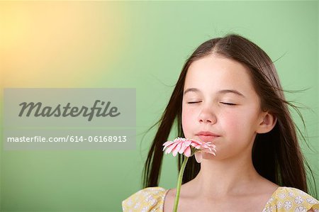 Girl sniffing flower Girl sniffing flower
