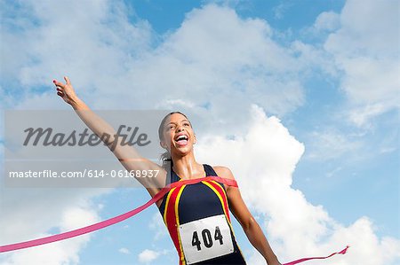 Female athlete crossing the finish line