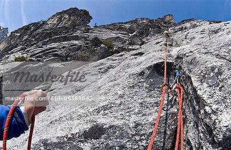 Climber belaying rock wall, Mount Berge, Cascade Range, Washington, USA