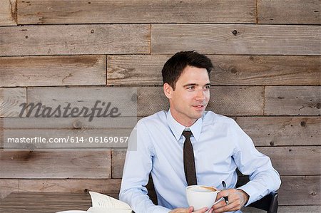 Businessman in cafe with coffee, portrait