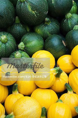 Round yellow and green courgettes