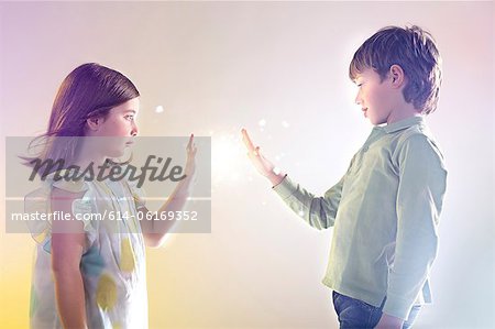 Girl and boy touching bright lights