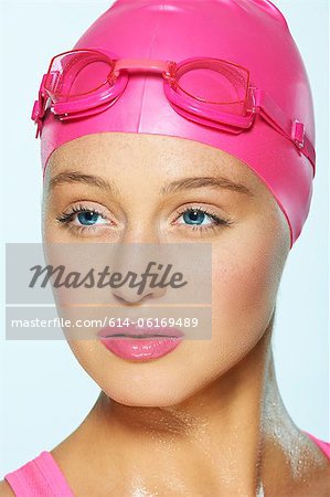 Female swimmer with pink goggles and cap