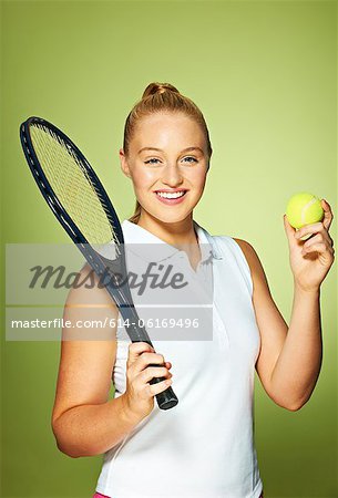 Young woman with tennis racket and tennis ball