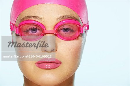 Female swimmer wearing pink swimming goggles
