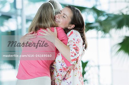 Adult mother and daughter embracing