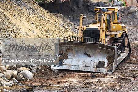 Bulldozer machine doing earthmoving work in mining