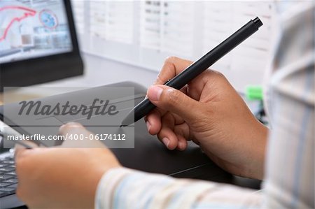 Graphic designer wotking using pen tablet in office