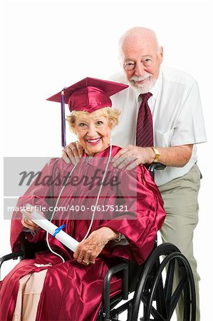 Senior woman in wheelchair graduates with the help of her supportive husband.  Isolated on white.