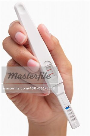 Hand holding positive result pregnancy test, against white background. You can easily set to negative result by patching the area around the 'T' so only the 'C' area has red strip