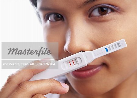 Young woman happily showing her pregnancy test result. **** PS : stitching on top part, because of tight crop composition of the original one ****