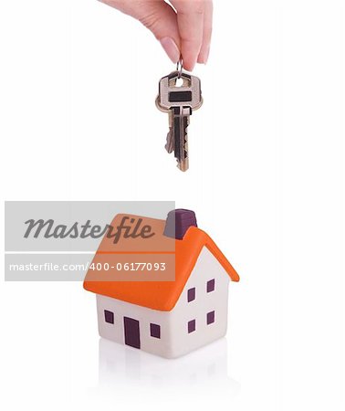 Conceptual image with small house and keys.Isolated on white