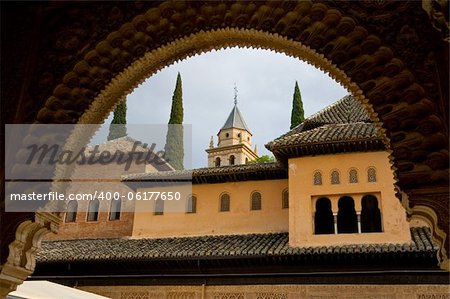 View of court of lions at alhambra through arches of the pillars.