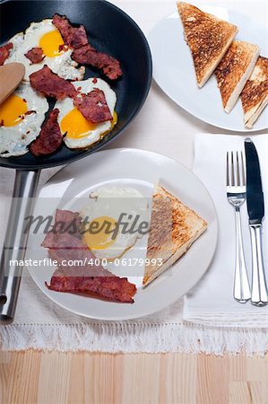 eggs sunny side up with bacon and toast typical english breakfast