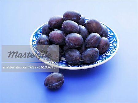 Fresh plums on plate