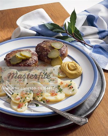 Meat patties and potato salad with bacon