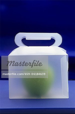 An apple in a carrying box An apple in a carrying box