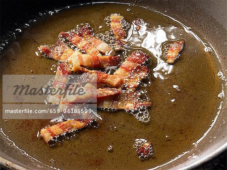 Frying pancetta (cured pork belly) in oil