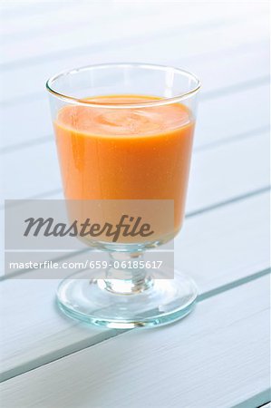 A glass of cream of carrot soup