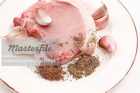 A pork chop with garlic and spices