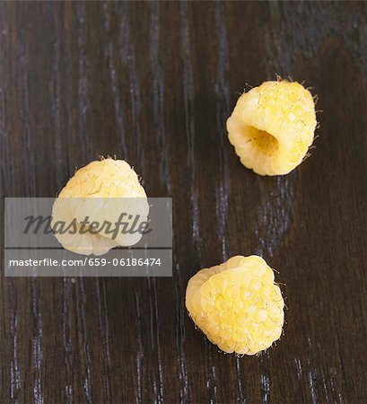 Three yellow raspberries