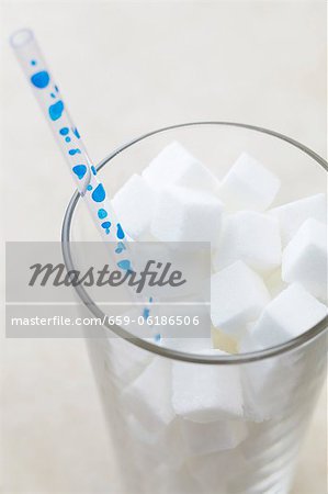 Glass Full of Sugar Cubes with a Straw Glass Full of Sugar Cubes with a Straw