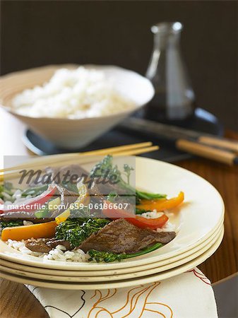 Beef and Broccoli Stir Fry Over White Rice with Chopsticks